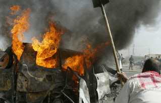 The corpses were dragged from the wreckage and television pictures showed one burnt body being kicked and stamped on, while at least two were tied to cars and driven through the city - Adults and children hacked the bodies to pieces, before lynching two of the charred remains from a bridge spanning the Euphrates River