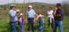 Enthusiastic participants "soak up" McEwen's knowledge on muddy floodplain McEwen-explains-to-enthusiastic-participants.jpg (60459 bytes)